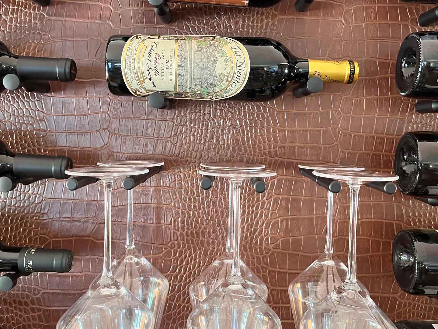 Front view of a leather wine wall display